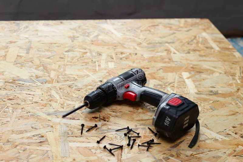 Screwdriver and screws on osb plywood royalty free stock photos